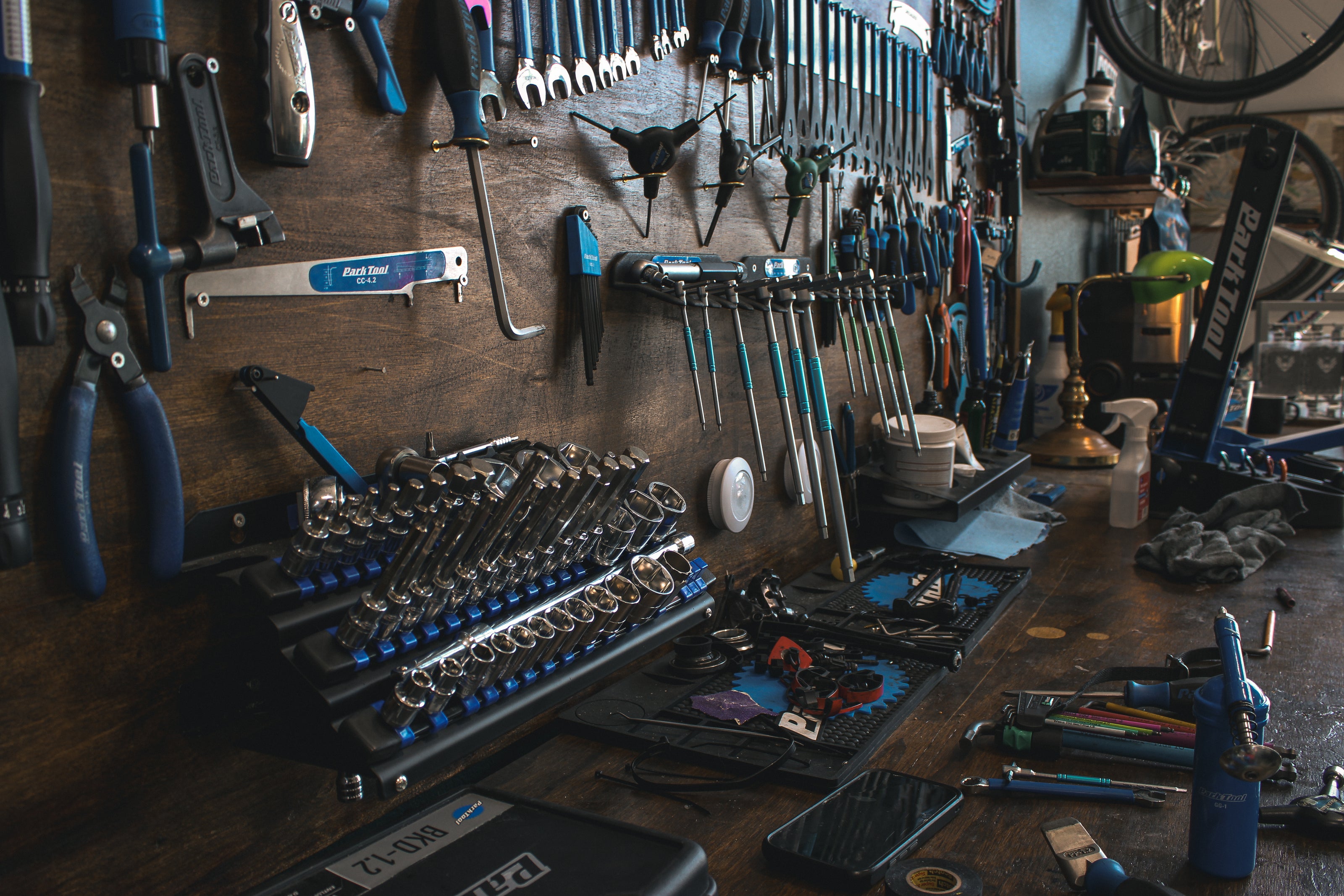 Workshop bench with tools and equipment on a wooden surface